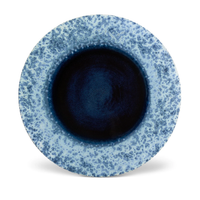 The L'Objet Terra Platter Charger Indigo features a round ceramic design with a dark blue center and lighter speckled rim, finished in glossy elegance. Perfect for refined settings, it's shown on a white background.