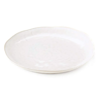The Burlington Dinnerware Cloud by Simon Pearce is a simple, round, white ceramic plate with an organic-edged design inspired by pinch-pot techniques, shown against a white background.