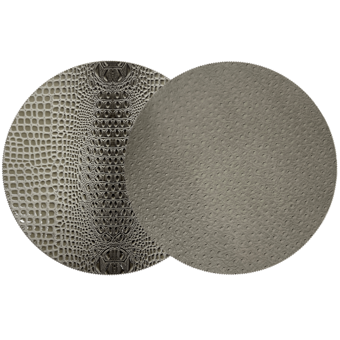 Two overlapping gray circles: the left has a reptile-scale texture, while the right resembles beaded placemat edges. Both evoke the Double Sided Round Keys Gator Placemat Set of 4 by Julian Mejia.
