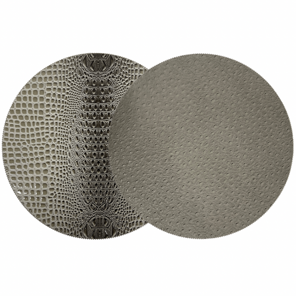 Two overlapping gray circles: the left has a reptile-scale texture, while the right resembles beaded placemat edges. Both evoke the Double Sided Round Keys Gator Placemat Set of 4 by Julian Mejia.