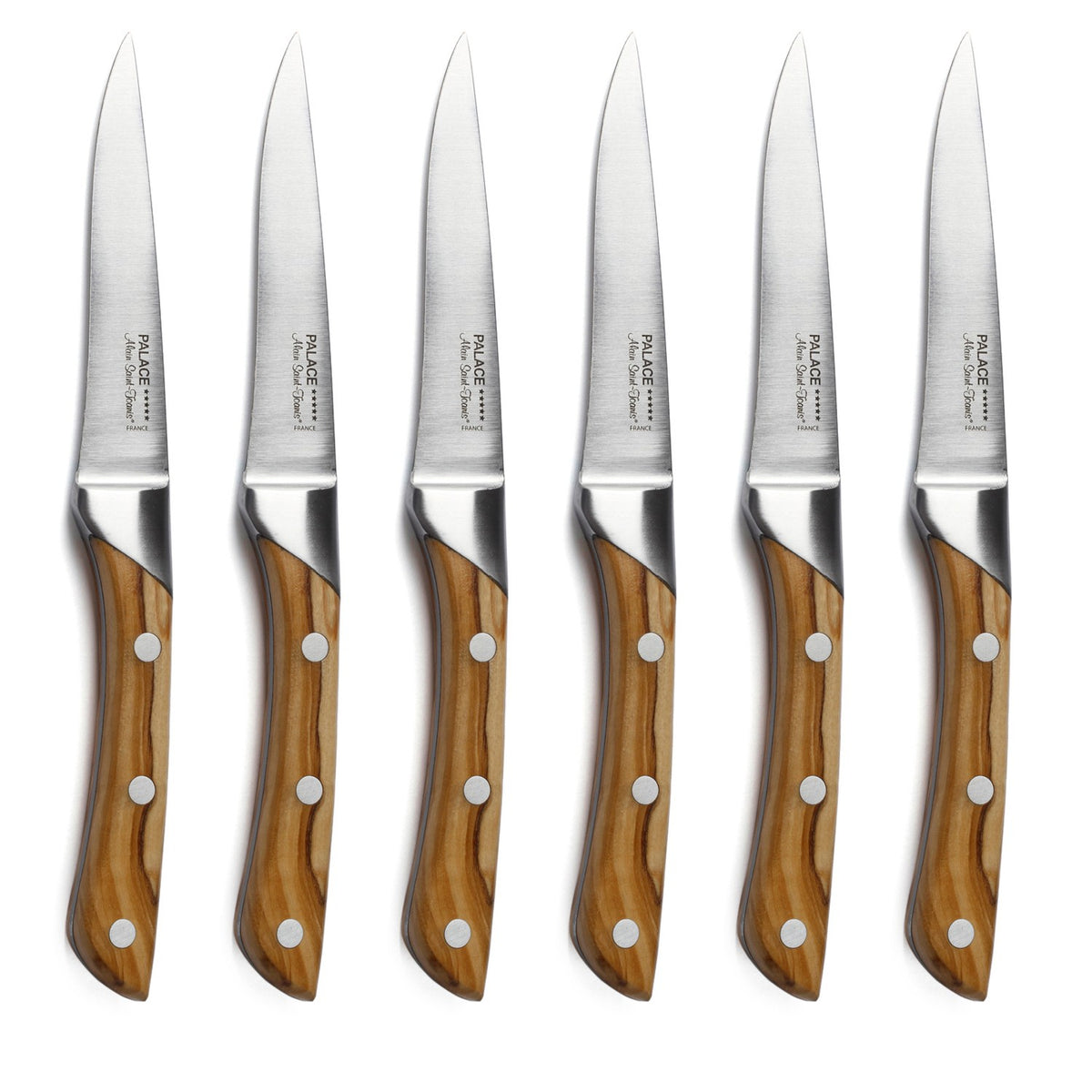 Six matching Alain Saint-Joanis Palace Steak Knives with polished wooden handles and silver blades are arranged vertically in a row on a white background.