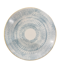 The Marie Daage Agate Dinnerware round ceramic plate features a white base, textured blue circular pattern, slightly raised edge, and thin gold rim. This luxury piece by Marie Daâge boasts a hand-painted, artisanal look.