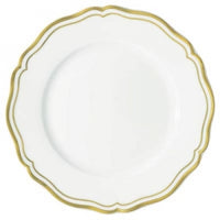 The Raynaud Polka Gold Dinnerware showcases a white ceramic plate with a scallop edge and two thin gold bands along the rim, bringing refined elegance to your table setting.