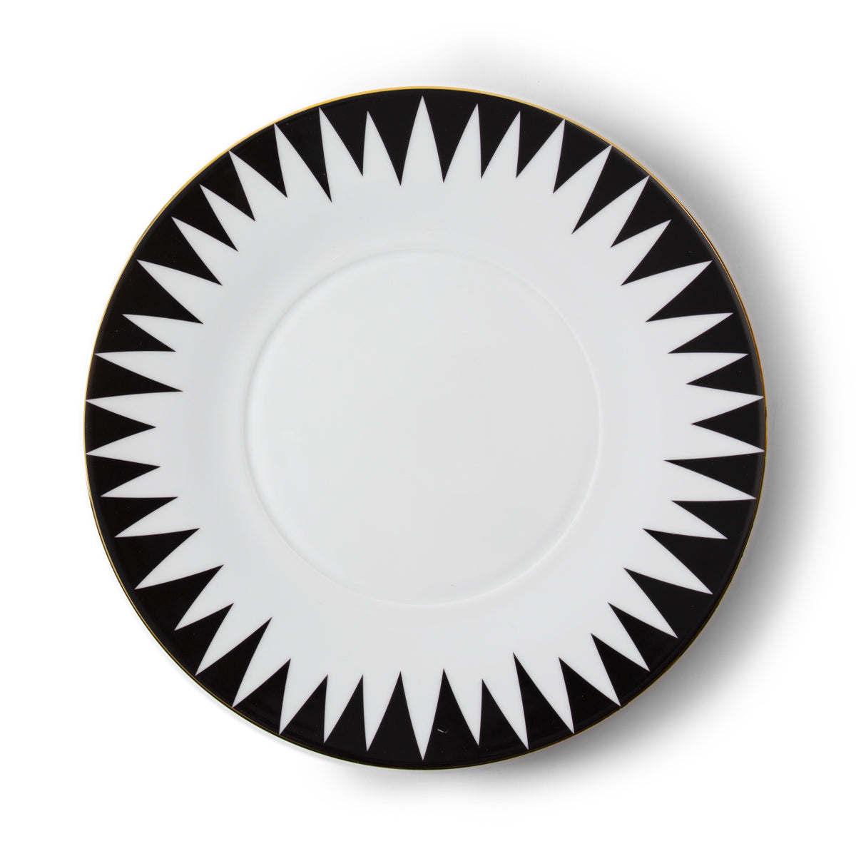 The Punk Dinnerware by Molecot features a round white Limoges porcelain plate with a bold black geometric sunburst rim and thin gold trim—a striking piece of modern tableware.