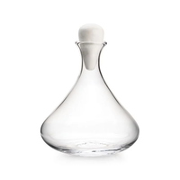 The Simon Pearce Vintner Wine Decanter With Marble Stopper features clear handmade glass with a wide, rounded base and narrow neck, topped by a sleek marble stopper, shown against a plain white background.