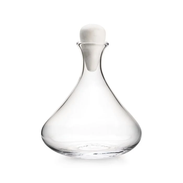 The Simon Pearce Vintner Wine Decanter With Marble Stopper features clear handmade glass with a wide, rounded base and narrow neck, topped by a sleek marble stopper, shown against a plain white background.