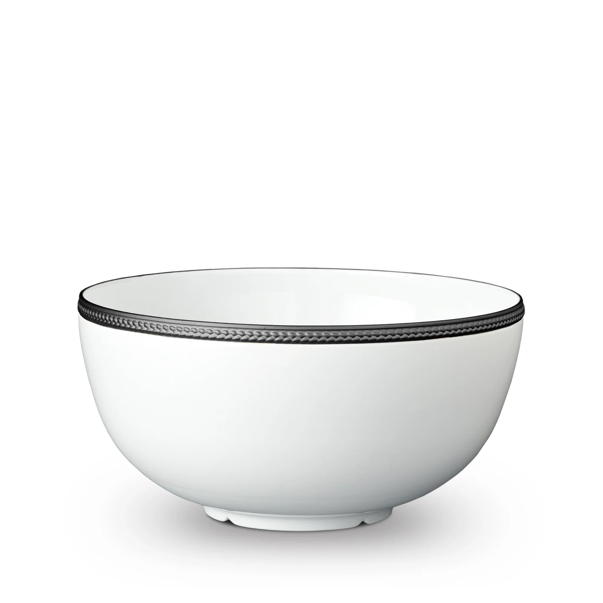 The Soie Tressée Black Dinnerware by L'Objet is a white ceramic bowl featuring an elegant textured black trim around the rim, evoking luxury porcelain, set against a white background.