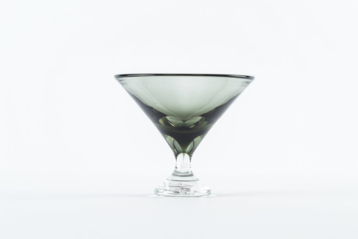 The Tyler Barry Design Footed Martini Glass features a wide rim and short stem, crafted from hand-blown glassware, and is shown empty against a plain white background.