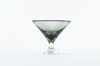 The Tyler Barry Design Footed Martini Glass features a wide rim and short stem, crafted from hand-blown glassware, and is shown empty against a plain white background.