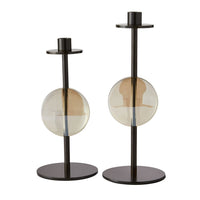 The Terrell Candleholders Set of 2 by Arteriors features two modern candleholders crafted from bronze-finished steel with round bases and circular, translucent amber glass accents at the center, each designed at a different height.