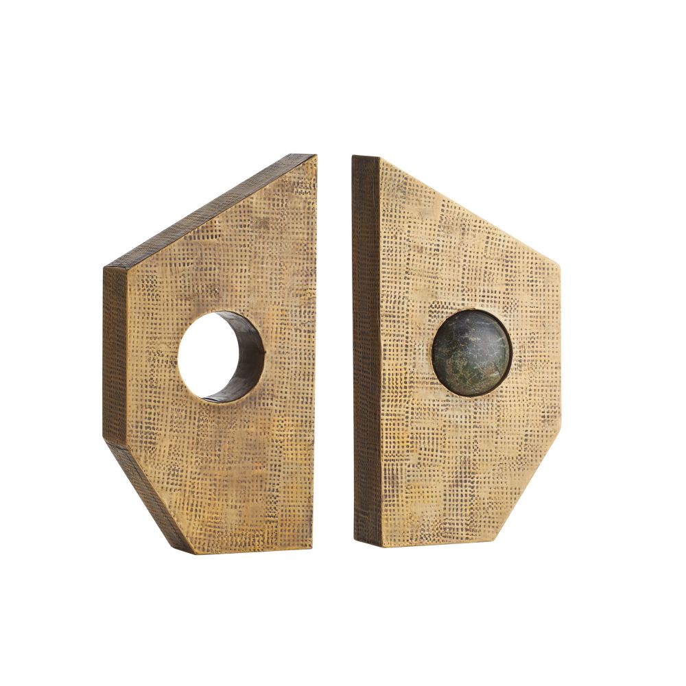 The Garrick Bookends Set of 2 by Arteriors features two angular gold bookends with striking geometric textures and a modern, artistic design. One bookend showcases a circular cutout, while the other displays a dark marble accent sphere. Reminiscent of antique brass pieces, this distinctive set blends bold style with sculptural form.