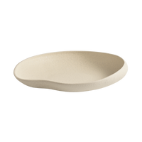 The Tefra Bowl by Greg Natale is a shallow, cream-toned ceramic plate with an organic, irregular shape and matte finish—ideal for chic interior styling or pairing with sculptural serveware—shown on a plain white background.