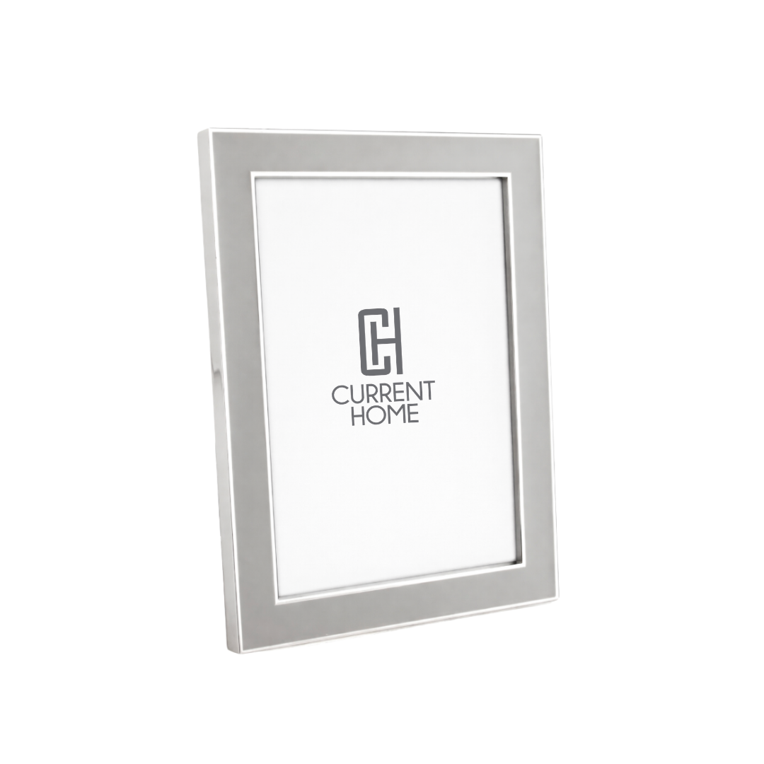 The Addison Ross Enamel Thin Chiffon Silver Frame is a sleek, modern rectangular photo frame with a smooth metallic finish. It stands upright, features a white insert with the logo, and supports both portrait and landscape display.