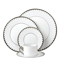 L'Objet's Aegean Filet Platinum Dinnerware set features white porcelain with scalloped dark borders and includes a dinner plate, salad plate, bread plate, teacup, and saucer—all in a matching, refined design.