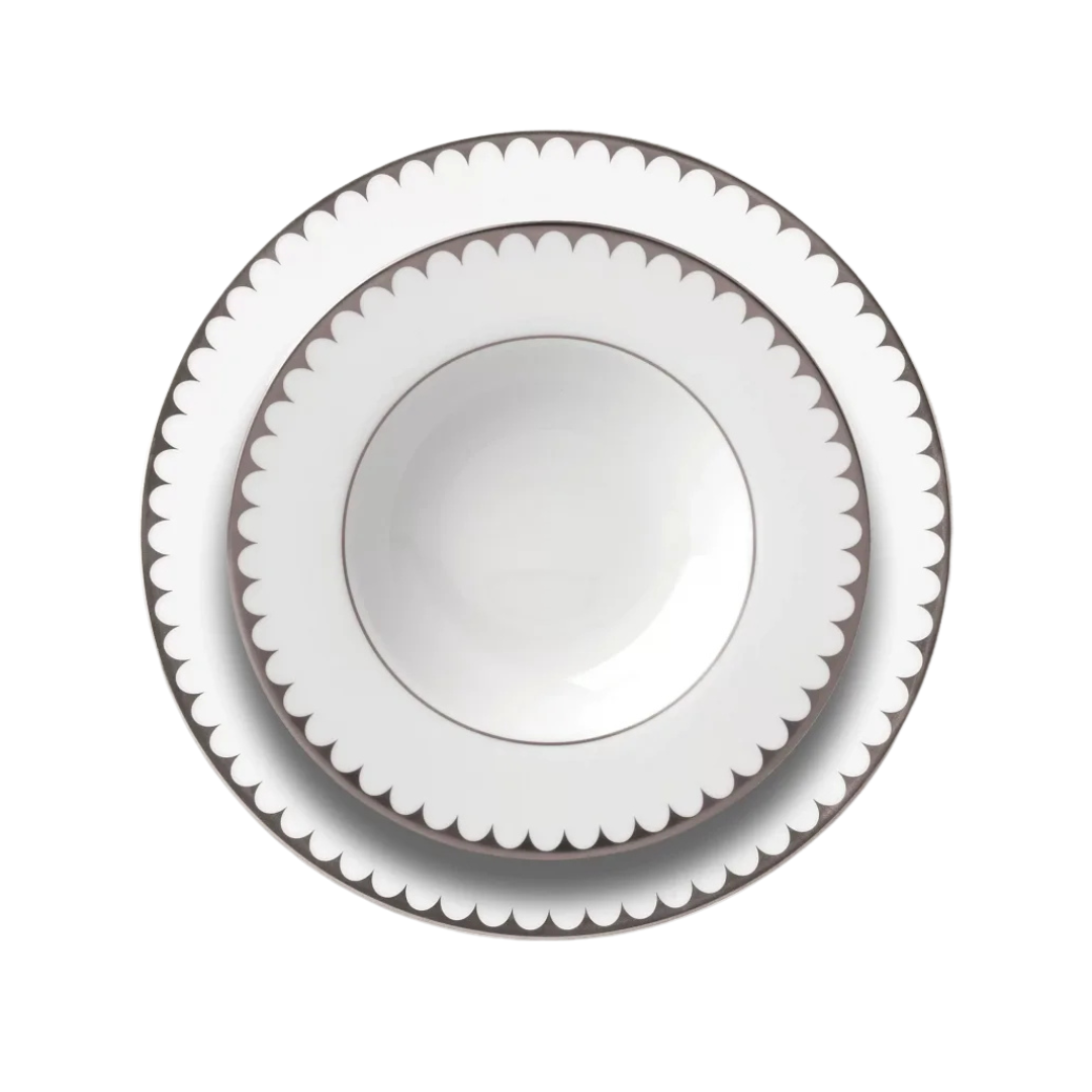 A set of three L'Objet Aegean Filet Platinum Dinnerware plates, stacked from largest to smallest on a white background, highlights the refined scalloped edges and platinum accents of this elegant porcelain collection.