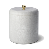 The Aerin Shagreen Ice Bucket features a cylindrical, white textured design with a matching lid and gold knob, bringing elegant luxury to any home bar.