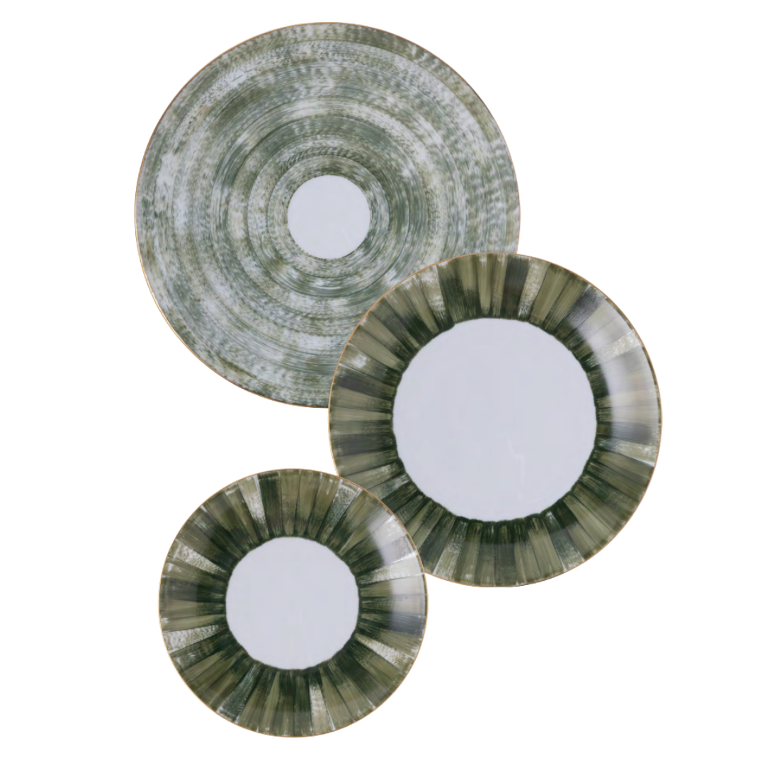 Three Marie Daage Panache ceramic plates by Marie Daâge, featuring green and white radial patterns, are clustered on a white background—the largest with a mottled design, the two smaller adorned with green striped rims.