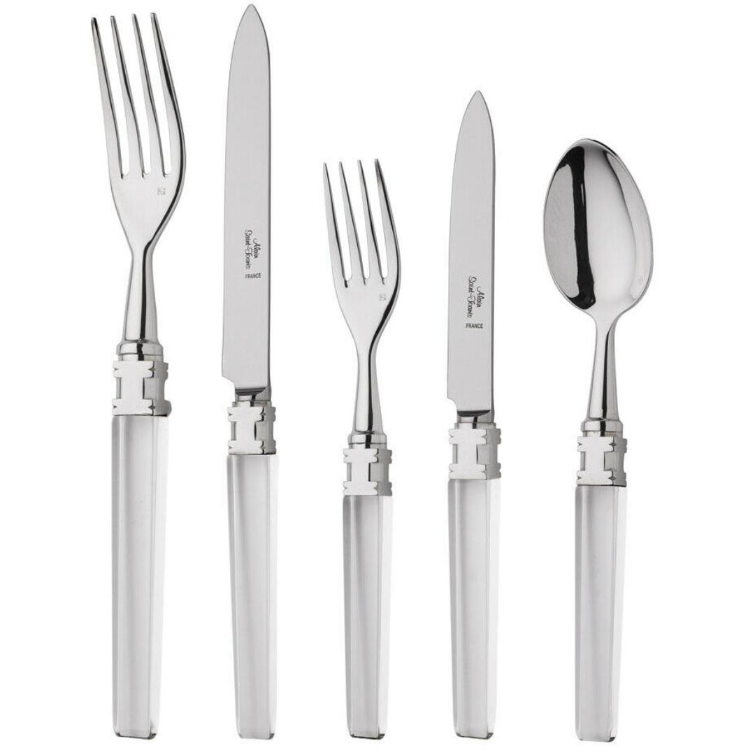The Alain Saint-Joanis Ingrid Flatware 5 Piece Setting—featuring a dinner fork, knife, salad fork, steak knife, and soup spoon with polished silver handles—is elegantly displayed on a white background.