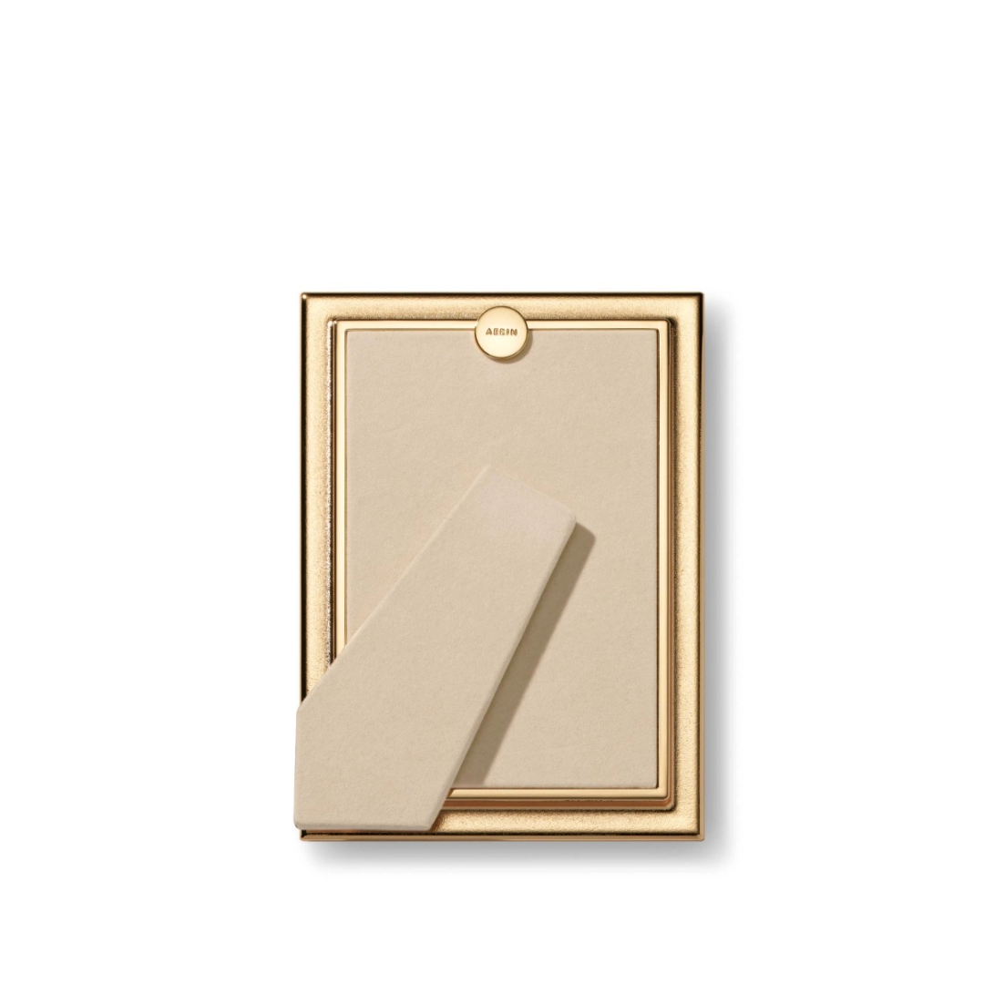 The Aerin Alessio Frame is a gold photo frame with a reeded design, beige backing, and stand, shown from the back against a white background—ideal as a desk frame for showcasing your favorite memories.