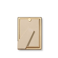 The Aerin Alessio Frame is a gold photo frame with a reeded design, beige backing, and stand, shown from the back against a white background—ideal as a desk frame for showcasing your favorite memories.