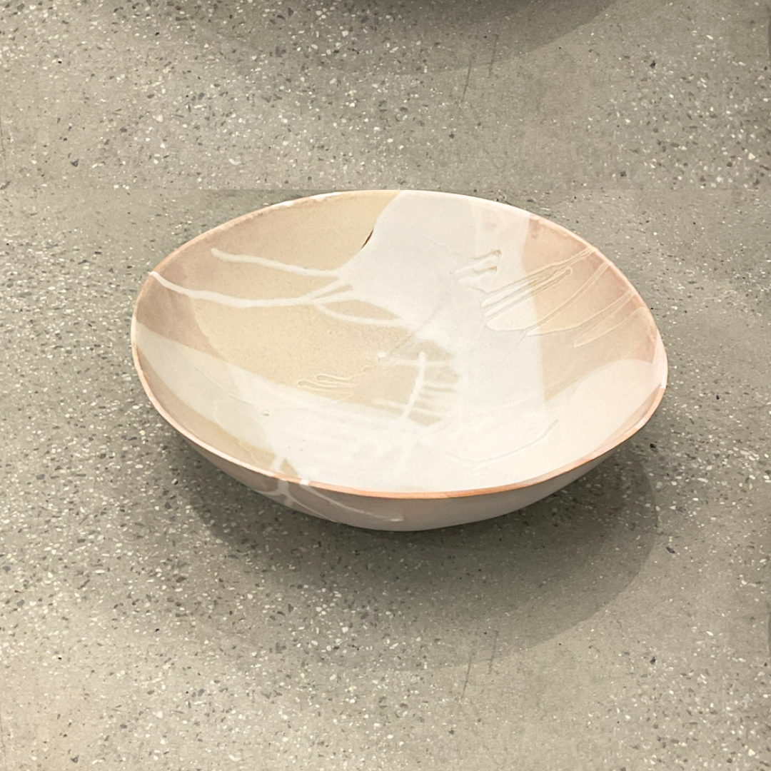 The Round Ceramic Bowls - Stone by Alex Marshall Studios feature a matte beige glaze with abstract white patterns, beautifully highlighting handmade craftsmanship as they rest on a speckled light-grey surface.