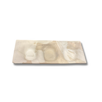 The Three Part Stone Rectangle Platter from Alex Marshall Studios is a handmade rectangular tray with an abstract marble design in cream, beige, and brown, featuring two circular indentations for creative serving.