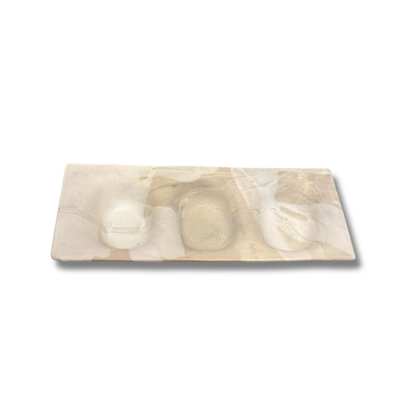 The Three Part Stone Rectangle Platter from Alex Marshall Studios is a handmade rectangular tray with an abstract marble design in cream, beige, and brown, featuring two circular indentations for creative serving.