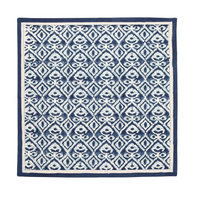 The Kim Seybert Alfresco Napkin Navy & Blue Set of 4 features a square cotton design with blue and white geometric and floral patterns, inspired by Indian block printing, and finished with a solid blue border.