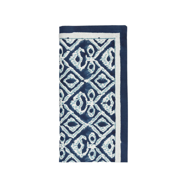 The Kim Seybert Alfresco Napkin Navy & Blue Set of 4 features folded cotton napkins with a blue and white geometric diamond pattern and a solid blue border, inspired by traditional Indian block printing—ideal for alfresco dining.