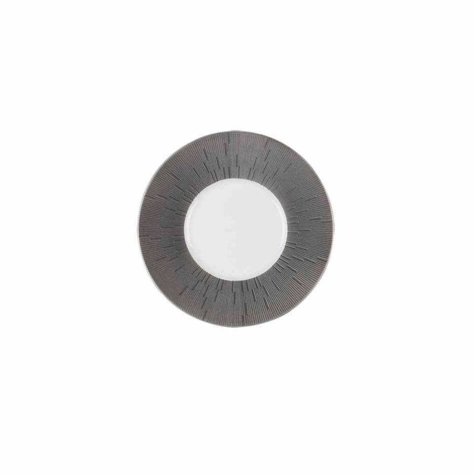 A single gray contact lens with a clear center and a patterned, radial design of thin black lines on white, inspired by the Haviland Anthracite Infini Dinnerware Grey.