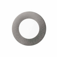 A circular metallic object with a hollow center and fine, radiating lines—reflecting the timeless elegance of Haviland’s Anthracite Infini Dinnerware Grey.