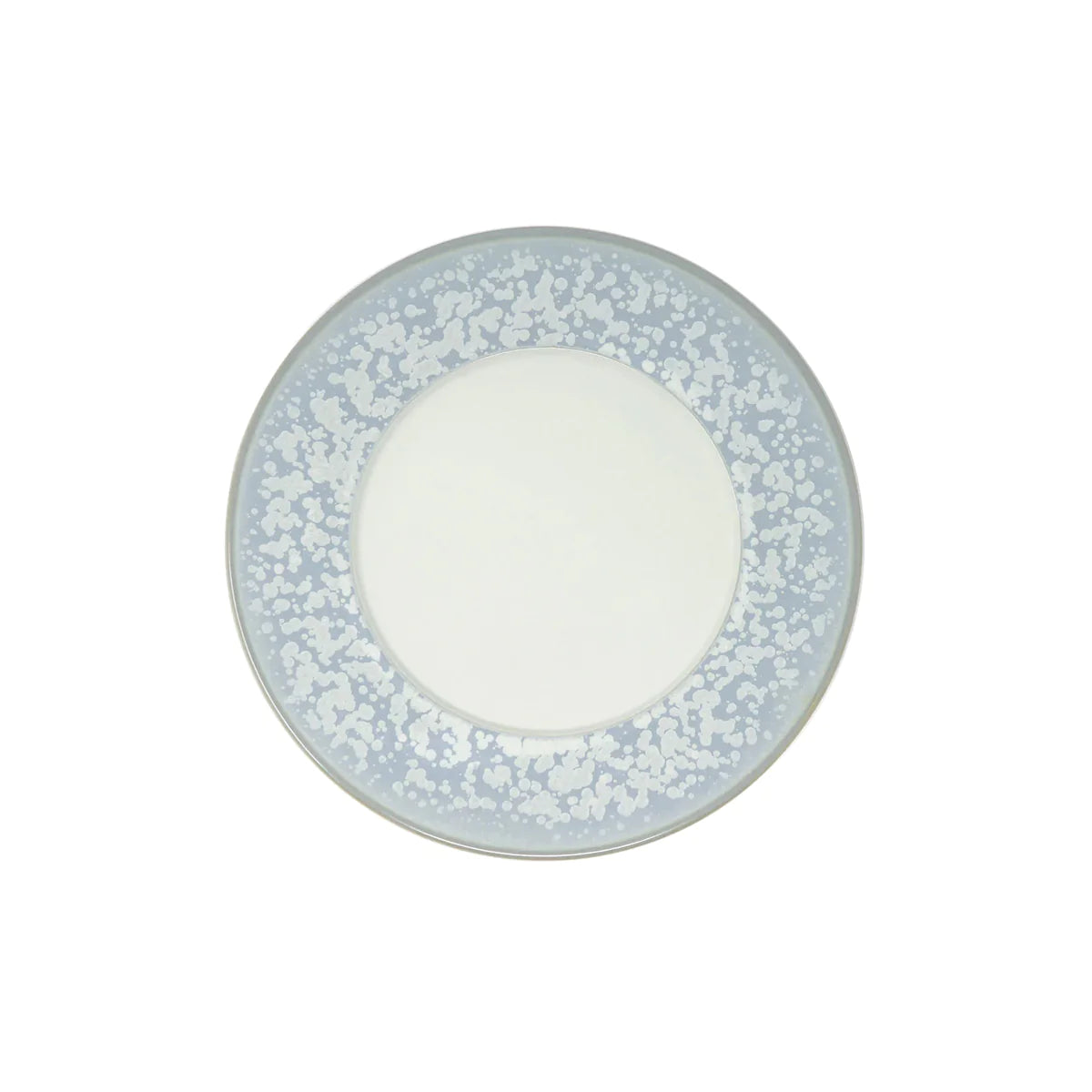 The Song Ocean Dinnerware by Jaune De Chrome is a round ceramic plate inspired by French design, with a plain white center and a wide, light blue speckled border.