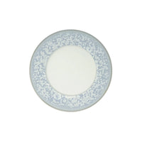 The Song Ocean Dinnerware by Jaune De Chrome is a round ceramic plate inspired by French design, with a plain white center and a wide, light blue speckled border.