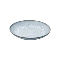 The Song Ocean Dinnerware by Jaune De Chrome is a round, shallow ceramic plate featuring a light blue and white speckled pattern reminiscent of classic French dinnerware, displayed on a plain white background.