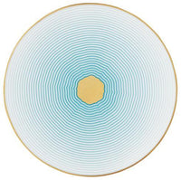 The Aura Dinnerware by Raynaud features a round plate with concentric light blue rings radiating from a central yellow circle, bordered by a thin gold rim. The clean geometric pattern offers a contemporary touch and is elegantly crafted in France.