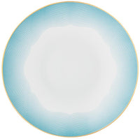 The Raynaud Aura Dinnerware features a round white plate with a wavy blue-lined border and thin gold rim. Its modern, elegant design includes subtle blue patterns. Crafted in France.
