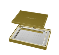 The Christofle Graphik Silver Plated Rectangular Tray, featuring a modern elegant design, is presented in an open olive green gift box with the Christofle logo embossed on the lid.