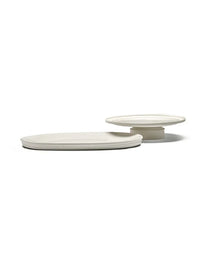 The Serax Dune Oval Platter Alabaster -18" is a minimalist off-white ceramic platter, flat and oval-shaped, displayed on a white background and inspired by ancient pottery.