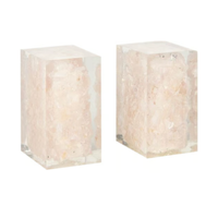 The Jessie Bookends Set by Made Goods features two rectangular resin bookends, each encasing a rough light pink rose quartz—ideal as decorative shelf accessories.