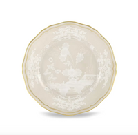 The Oriente Italiano Beige Meringa plate by Ginori 1735 features elegant scalloped edges, a refined white floral pattern, and a delicate gold rim, showcased on a white background—a stunning addition to any table from Ginori 1735’s celebrated fine porcelain dinnerware collection.