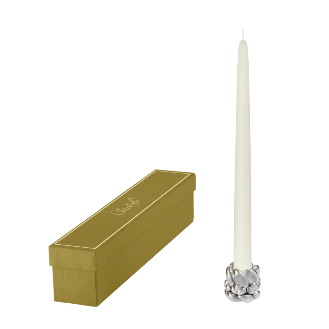 The Babylone Candlestick Holder by Christofle, featuring a tall ivory candle, is placed beside a gold rectangular lidded box on a white background—an elegant décor choice for refined interiors.