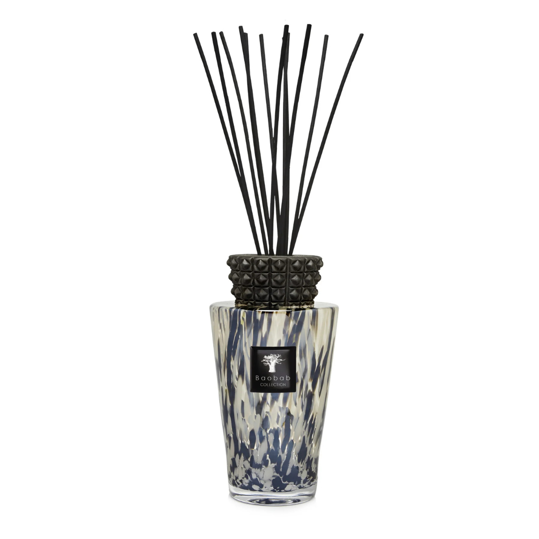 The Baobab Totem Pearls Black Diffuser features a black and white spotted glass design, black pearl finish, glazed ceramic cap, fragrance oil with black reeds, and is labeled with the Baobab Collection logo.