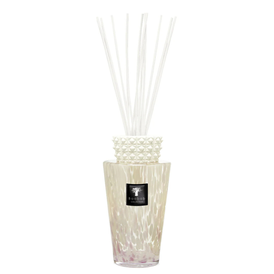 The Totem Pearls White Diffuser by Baobab features a decorative glass design with a textured white collar, filled with liquid and white reeds—an elegant touch to enhance your home fragrance experience.