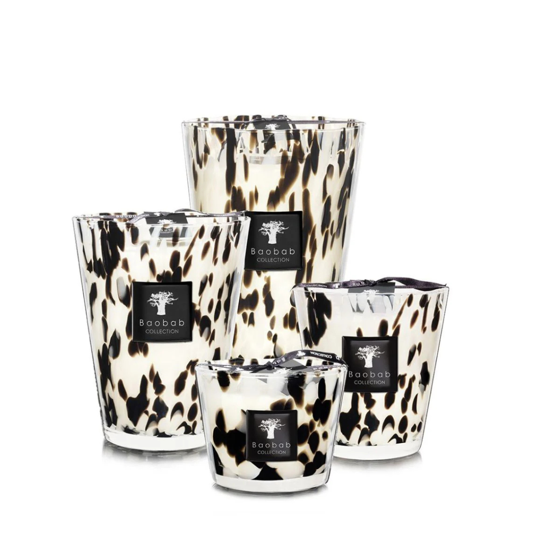 Four Baobab Pearls Candles in hand-blown glass with black and brown spots, arranged in different heights and sizes on a white background.