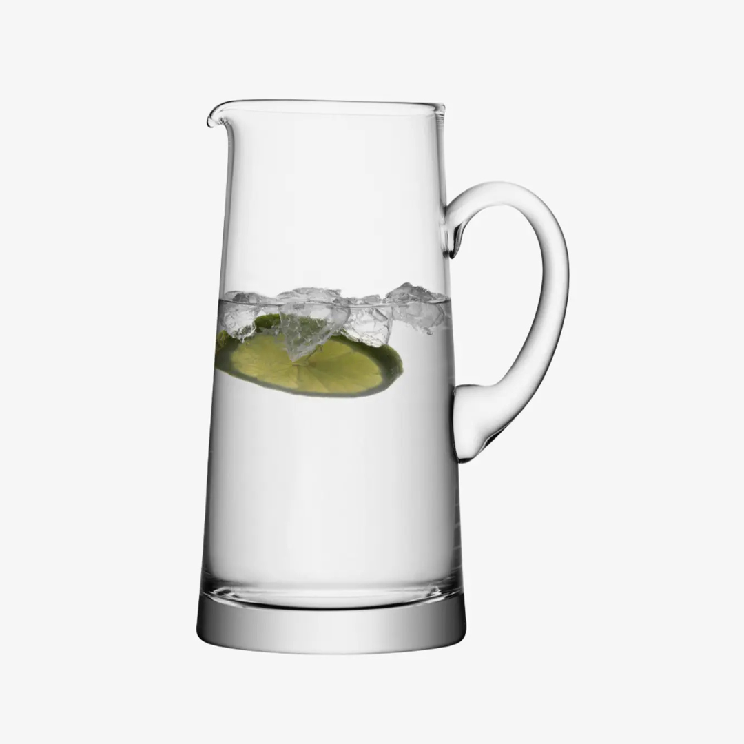 The LSA Bar Tapered Pitcher is shown filled with water, ice cubes, and a slice of lime, set against a plain white background.