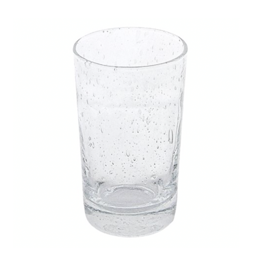 A Mariposa Bellini Glassware tumbler, featuring small bubbles and textured imperfections, stands upright on a white background, partially filled with water.
