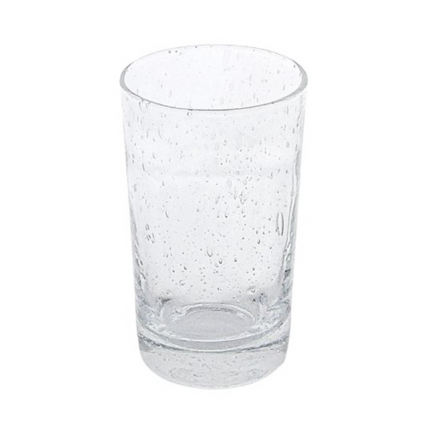 A Mariposa Bellini Glassware tumbler, featuring small bubbles and textured imperfections, stands upright on a white background, partially filled with water.