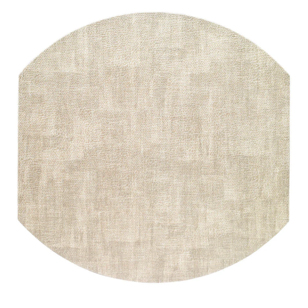 The New Luster Elliptic Placemat Set of 4 by Bodrum is shown in light beige with a textured, octagon-shaped design and slightly rounded edges, featuring elegant fabric and a subtle woven look against a white background.
