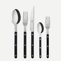 The Sabre Bistrot Solid Flatware 5 Piece Setting - Shiny includes a tablespoon, dinner fork, knife, teaspoon, and salad fork with black handles, shown upright on a white background. Paris-inspired design from the Bistrot collection.