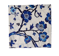 Elevate your table decor with the Deborah Rhodes Oriental Blossom Napkin Set of 4, featuring a white background adorned with blue floral patterns, branches, and various blue flowers and leaves—perfect for stylish dining.